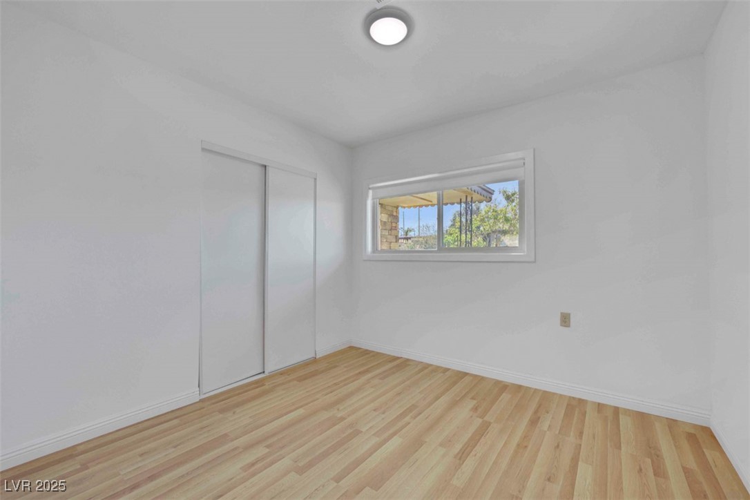 11 California Way Henderson, NV 89015 - Photo 11 of 17 Unfurnished bedroom with light wood-style floors and a closet