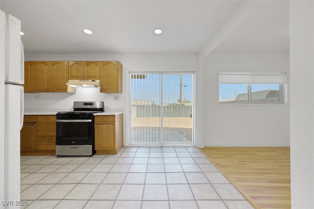 11 California Way Henderson, NV 89015 - Photo 6 of 17 Kitchen featuring gas range, light countertops, light tile patterned flooring, plenty of natural light, and recessed lighting