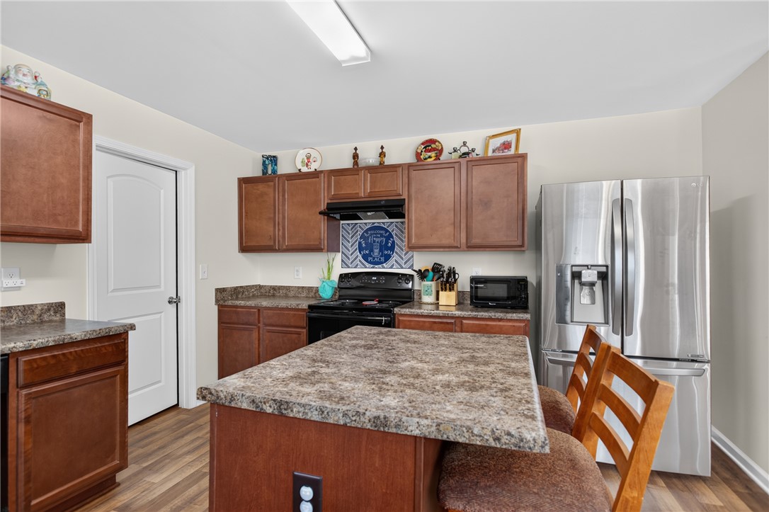 1081 Edenbrooke Circle Anderson, SC 29621 - Photo 12 of 46 A well-equipped kitchen features a central island, rich cabinetry, and modern stainless steel appliances.
