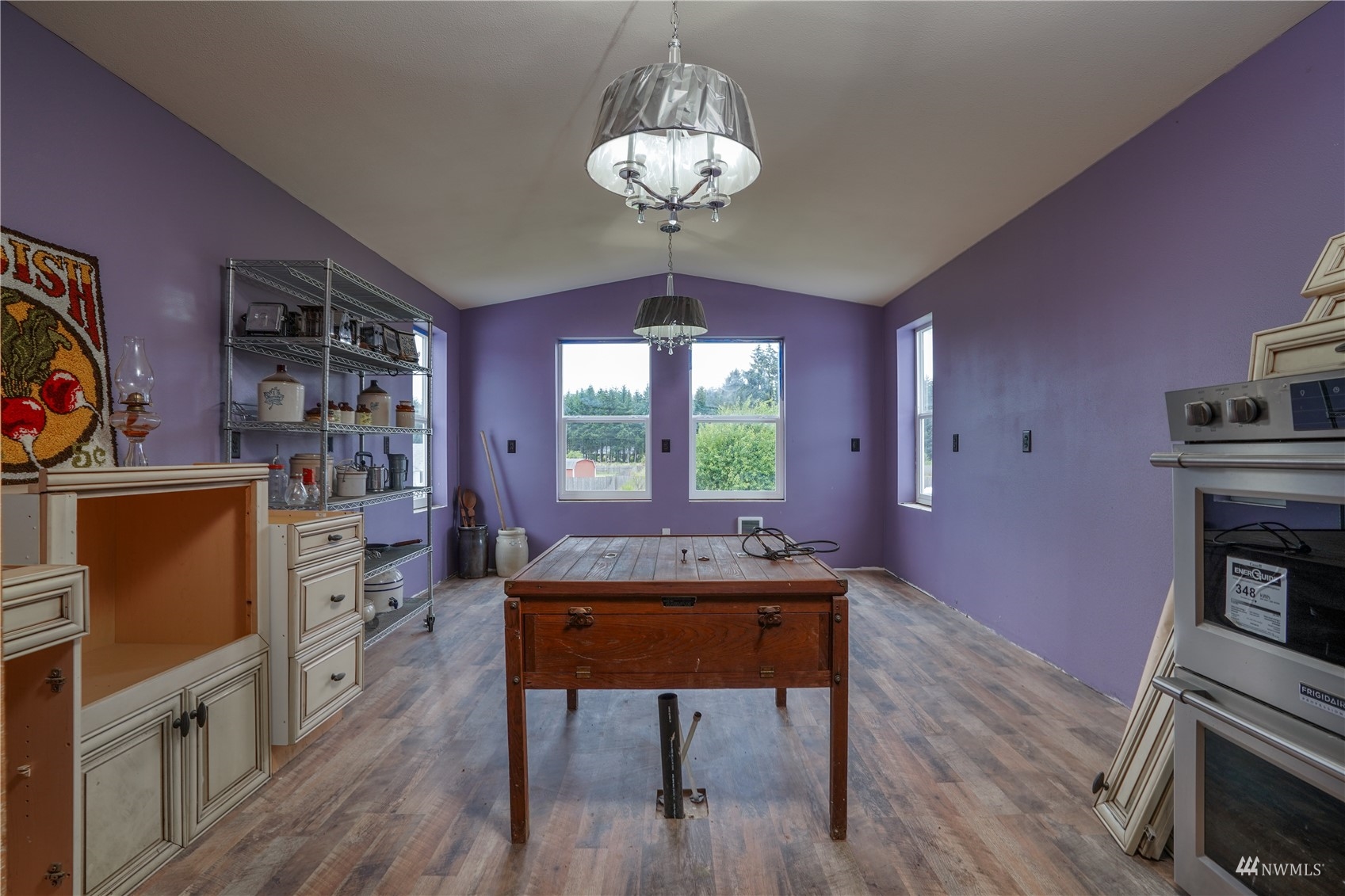 10542 School Land Road Southwest Rochester, WA 98579 - Photo 34 of 40 a dining room with furniture a chandelier and wooden floor