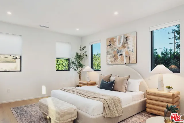 a bedroom with a bed and a couch