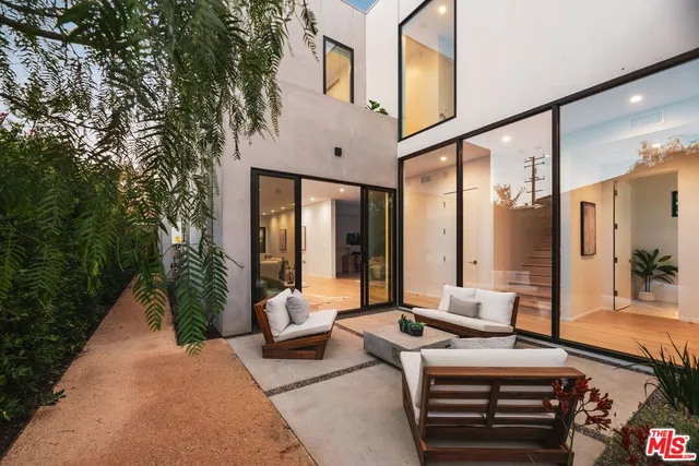 a balcony with furniture and a potted plant