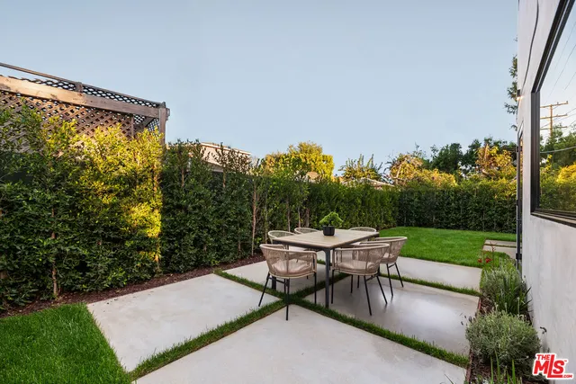 a view of a backyard with sitting area