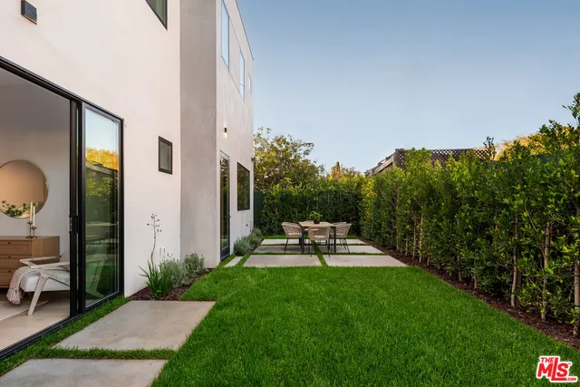 a view of a backyard with sitting area