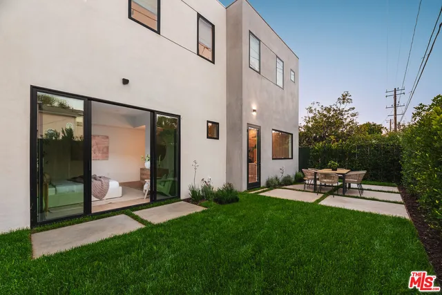 a view of a chair and table in front of a house