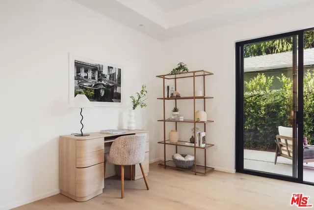 a dining room with furniture and a window