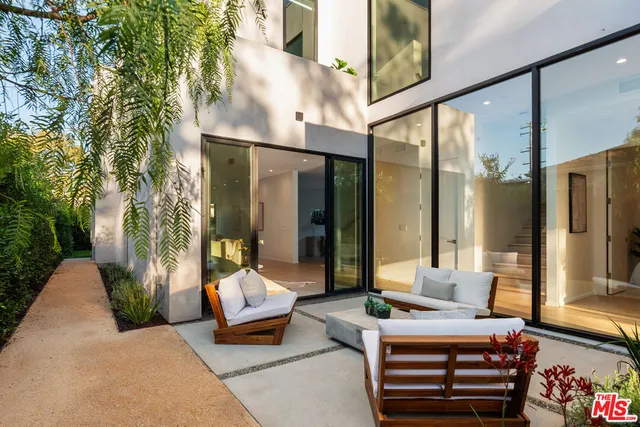 a balcony with furniture and a potted plant