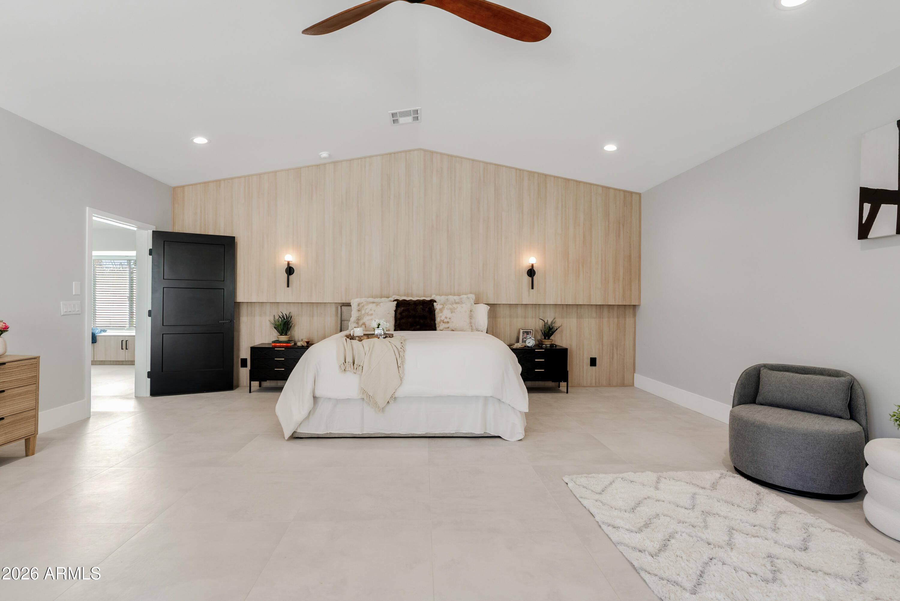 7717 North 7th Avenue Phoenix, AZ 85021 - Photo 13 of 31 a spacious bedroom with a bed and a couch