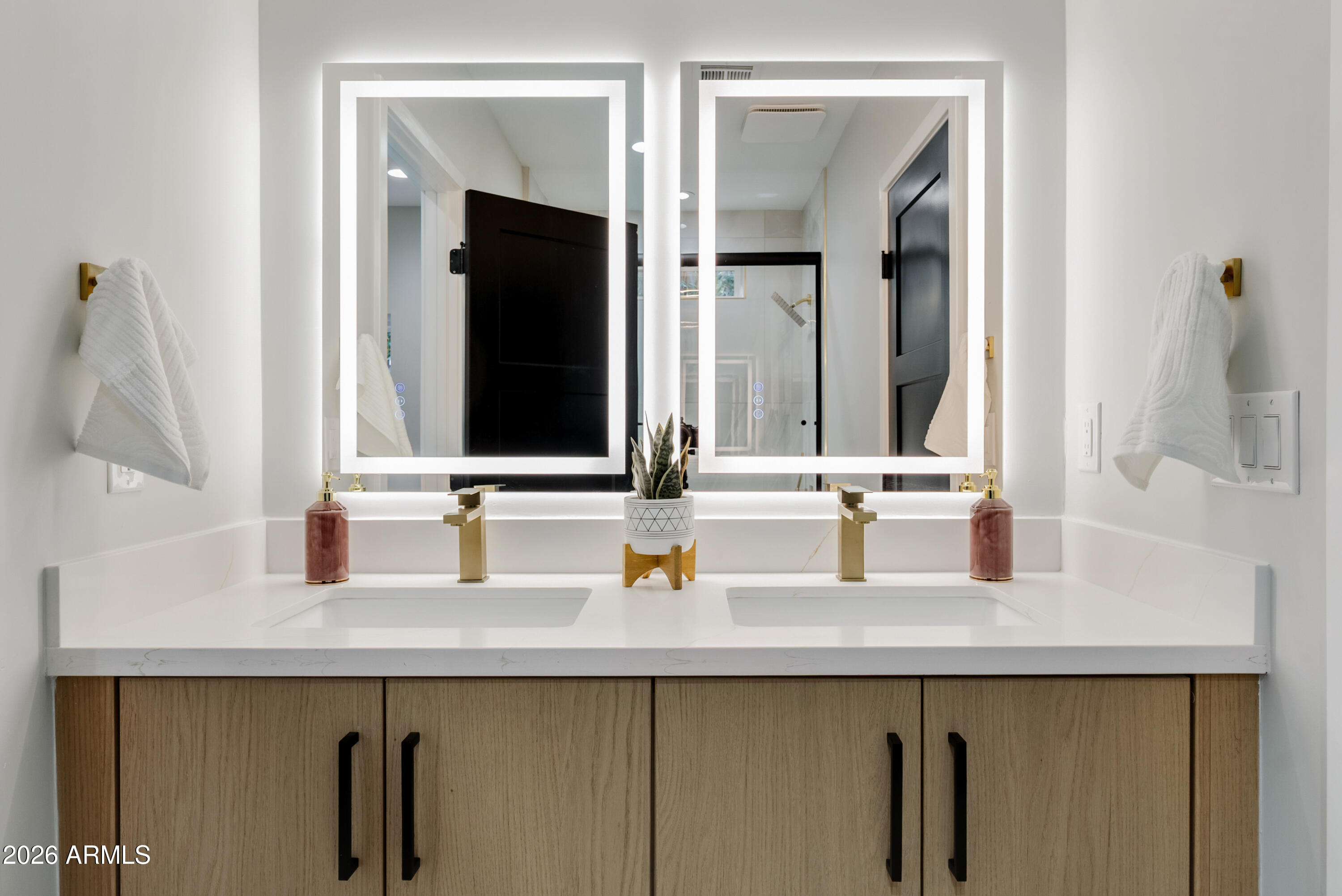 7717 North 7th Avenue Phoenix, AZ 85021 - Photo 17 of 31 a bathroom with double vanity and a mirror