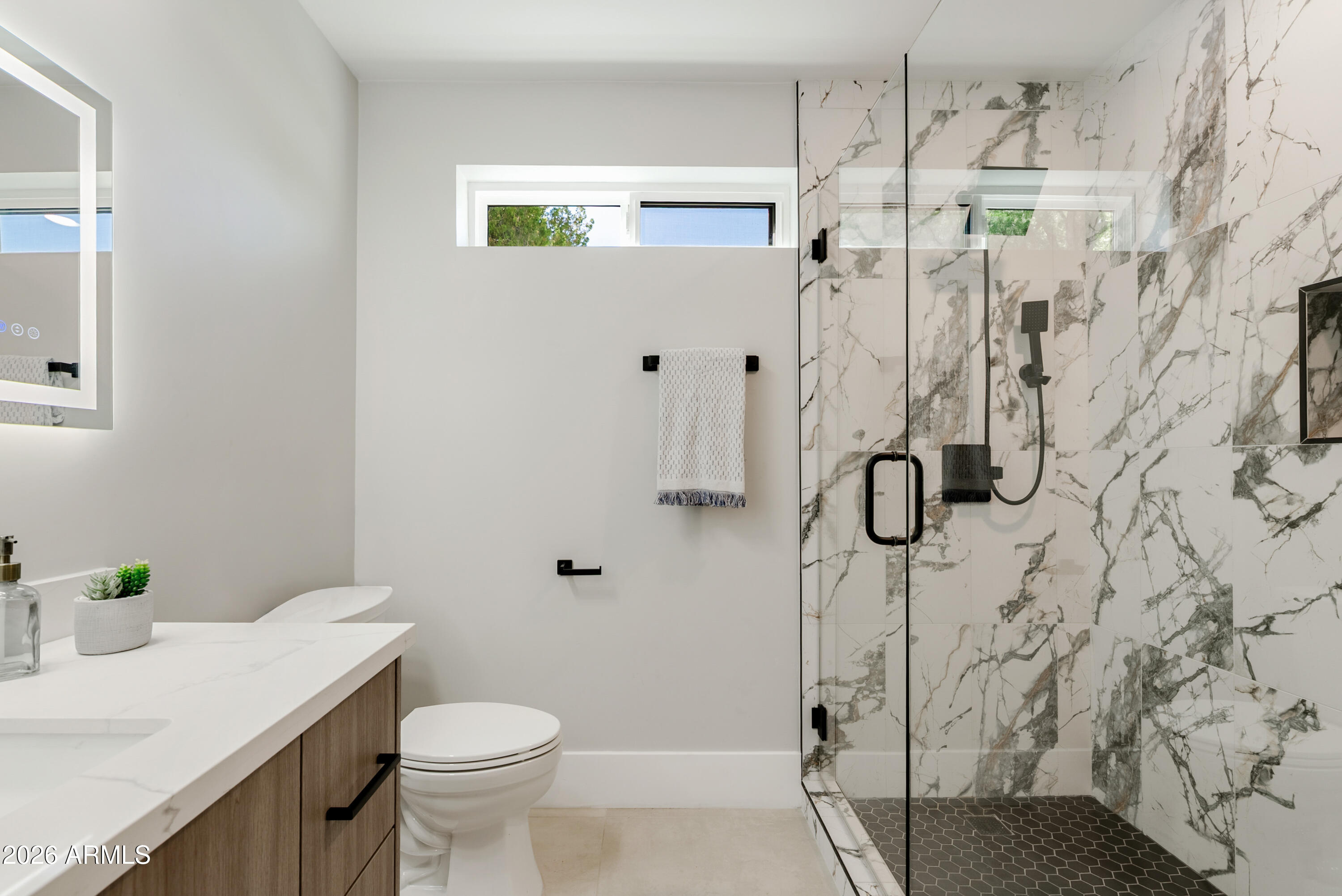 7717 North 7th Avenue Phoenix, AZ 85021 - Photo 23 of 31 a bathroom with a sink toilet and shower