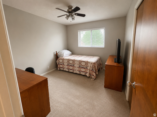 1020 Wilmar Place Centerville, UT 84014 - Photo 11 of 22 Room featuring light neutral wall paint, a window with white blinds, and a ceiling fan with multiple light fixtures