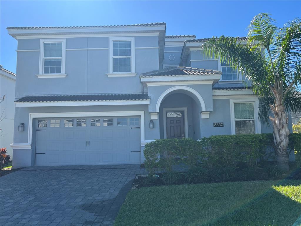 8830 Interlocking Court Davenport, FL 33896 - Photo 1 of 1 a front view of a house with garden