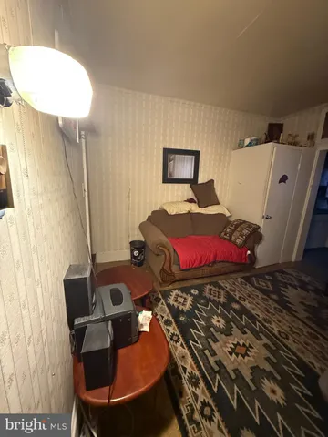 a room with gym equipment and a rug