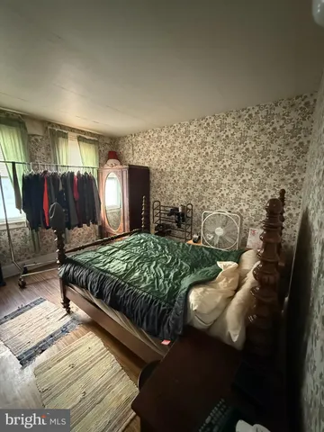 a bed sitting in a room next to a window