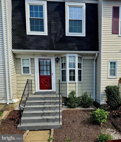 a front view of a house with a small yard