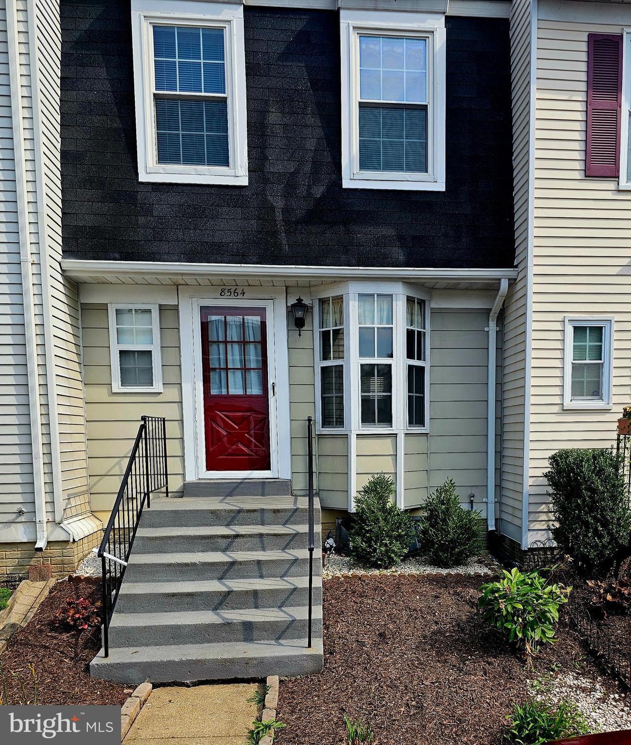 a front view of a house with a small yard