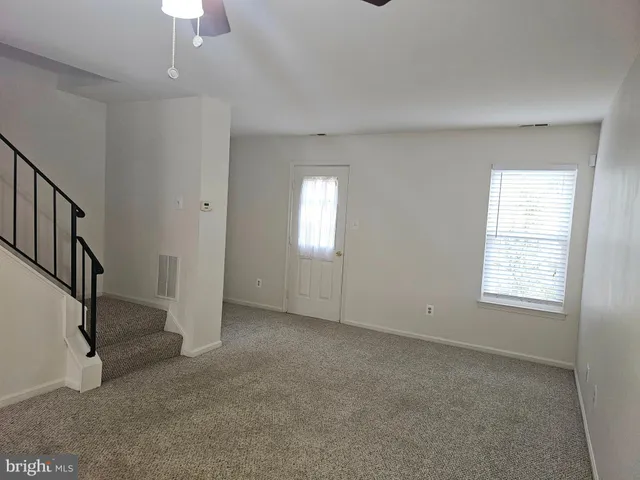 an empty room with windows and entrance