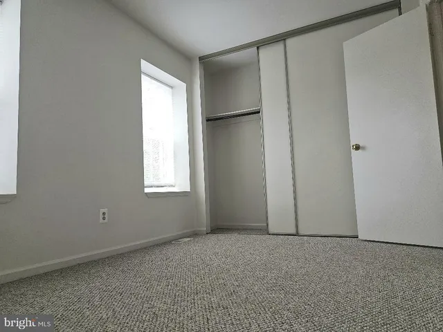 an empty room with closet area