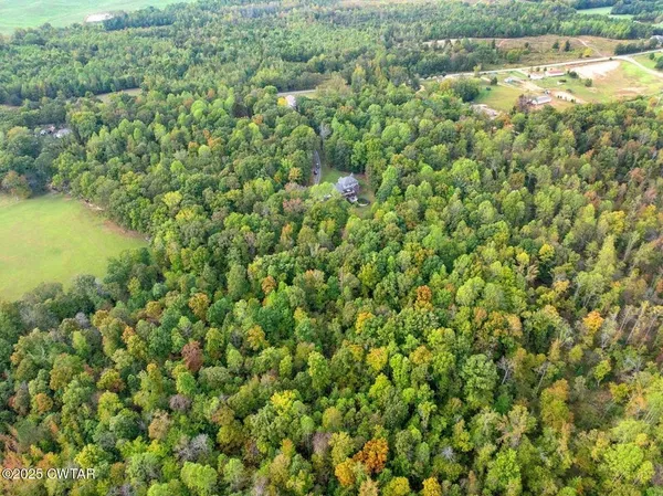 an aerial view of a houses with yard