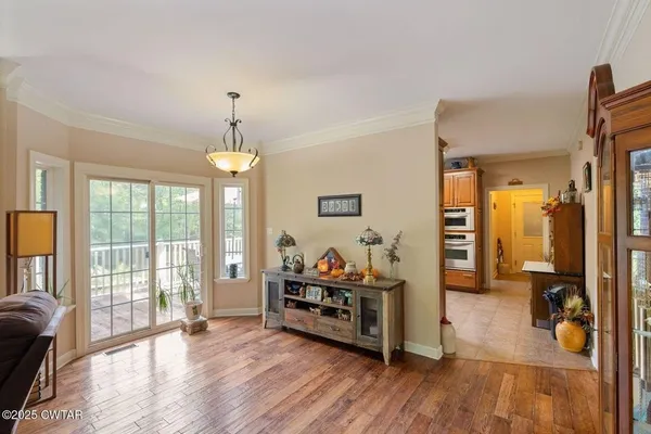 a view of a livingroom with furniture and hardwood floor