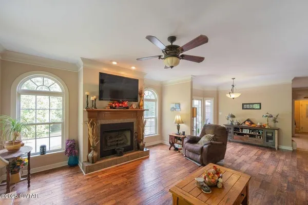 a living room with furniture fireplace and flat screen tv