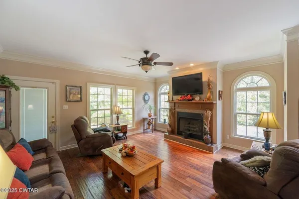 a living room with furniture a fireplace and a flat screen tv