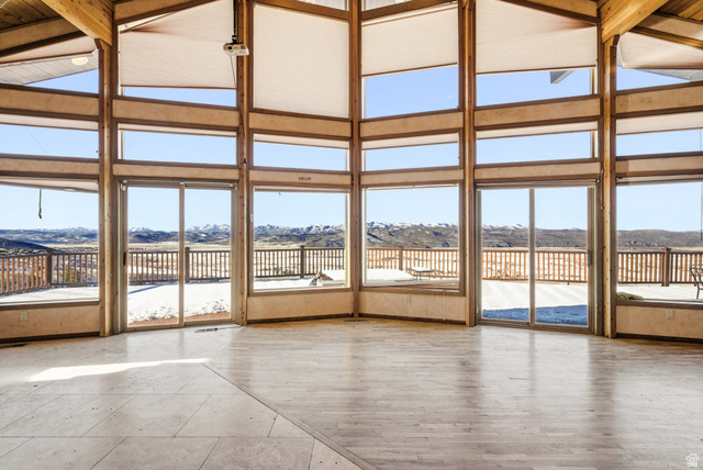 3090 North Rocky Road Kamas, UT 84036 - Photo 4 of 17 Unfurnished sunroom featuring healthy amount of natural light, a mountain view, and vaulted ceiling