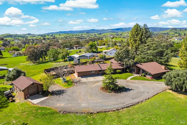 a front view of a house with a yard and outdoor seating