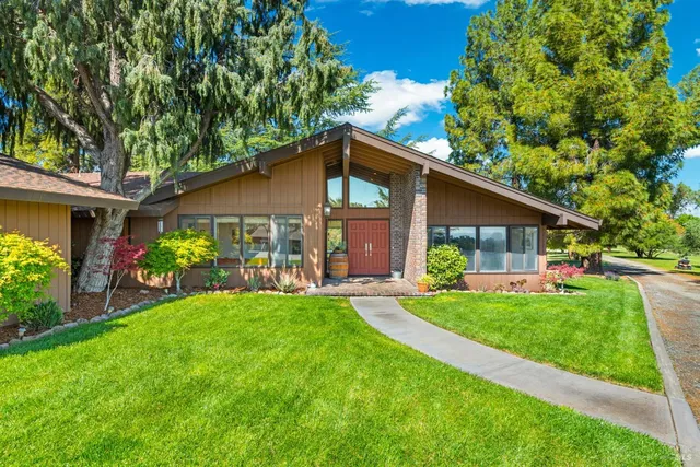 a kitchen with stainless steel appliances granite countertop a stove a sink and a wooden cabinets