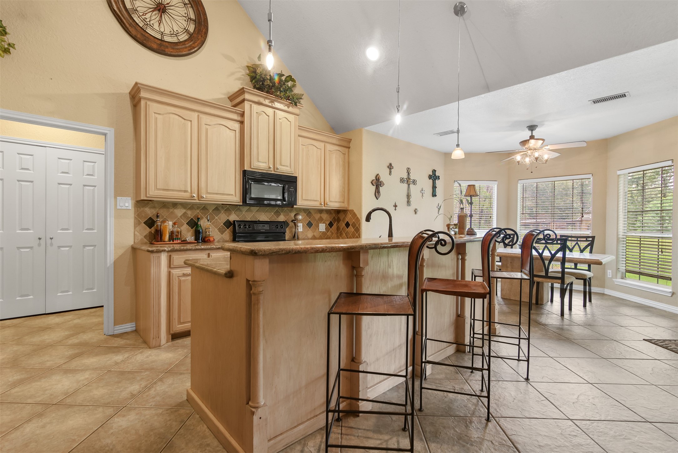 11692 Clark Lane Conroe, TX 77385 - Photo 7 of 35 Another view of the kitchen with large breakfast bar enhanced by decorative columns across the back.