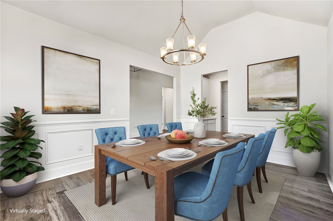 142 Juniper Hill Drive Easley, SC 29642 - Photo 8 of 47 Elegant dining space featuring a vaulted ceiling and classic wainscoting.