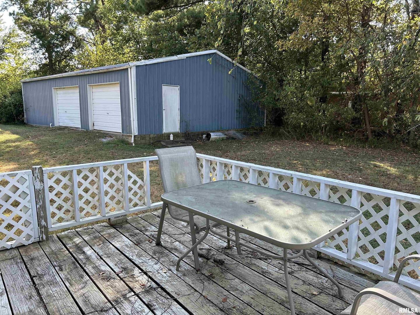 744 Cardinal Road Carbondale, IL 62901 - Photo 30 of 38 a view of a roof deck with table and chairs with wooden floor and fence