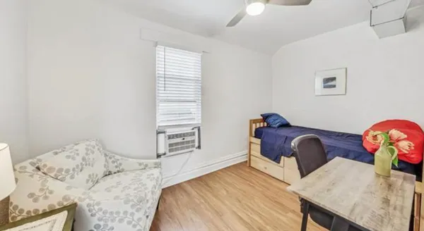 a bedroom with a bed and a dresser