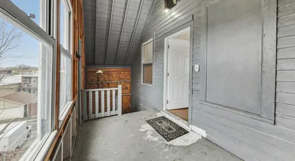 a view of a door and wooden floor