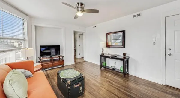 a living room with furniture and a flat screen tv