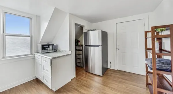 a kitchen with stainless steel appliances a refrigerator and a stove top oven
