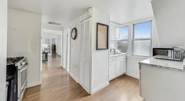 a kitchen with a refrigerator sink and cabinets
