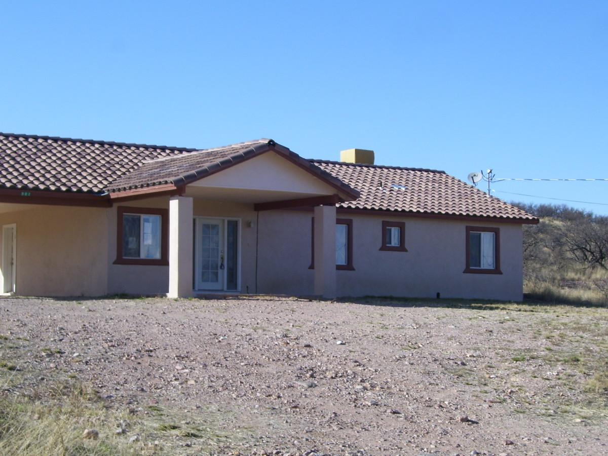 582 Ruben Court Rio Rico, AZ 85648 - Photo 2 of 6 a front view of a house with a yard