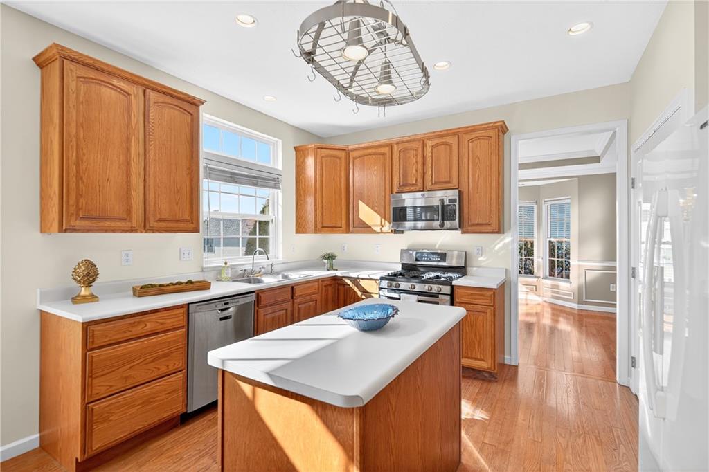 809 Wible Run Road Pittsburgh, PA 15209 - Photo 11 of 36 a kitchen with a stove a sink and a refrigerator