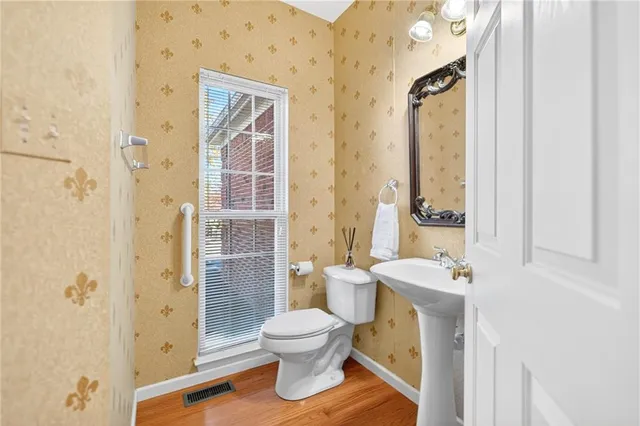 a white toilet sitting next to a bathroom sink