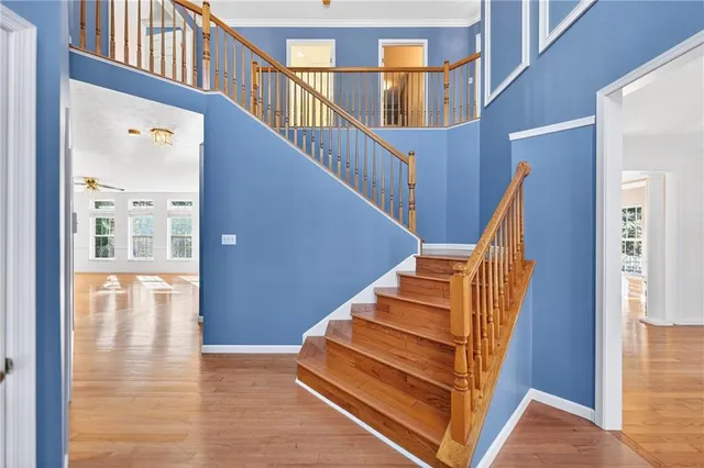 a view of staircase with lots of frames on wall and windows