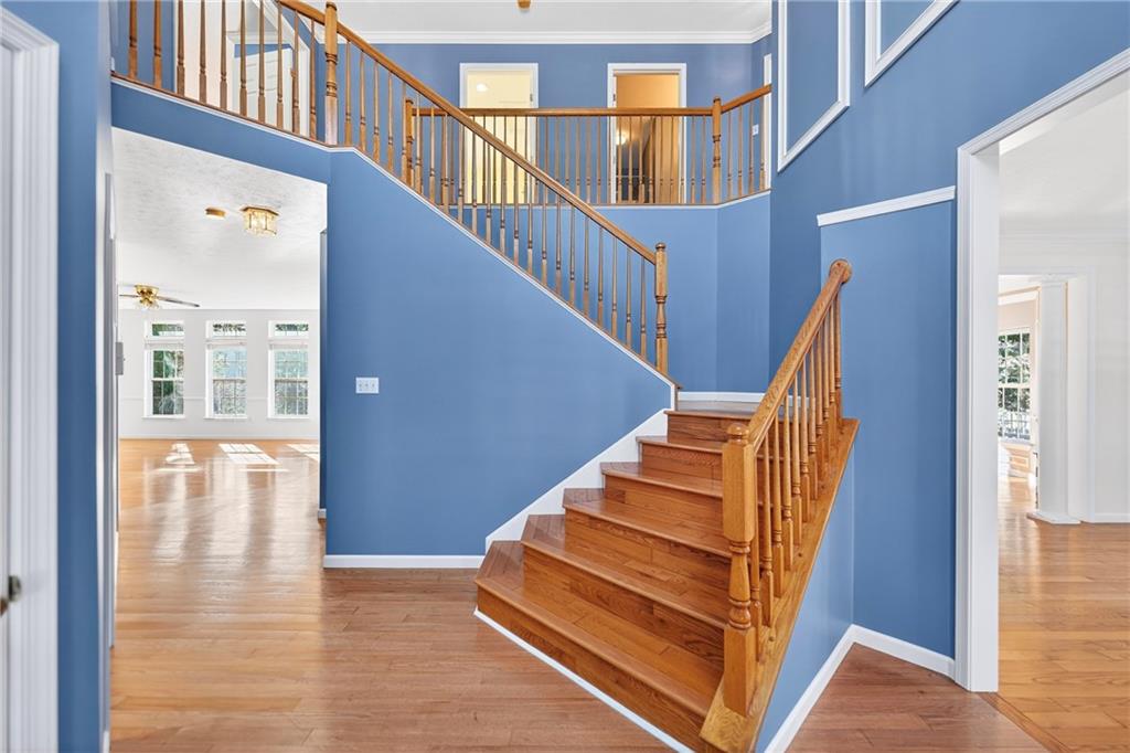 809 Wible Run Road Pittsburgh, PA 15209 - Photo 16 of 36 a view of staircase with lots of frames on wall and windows