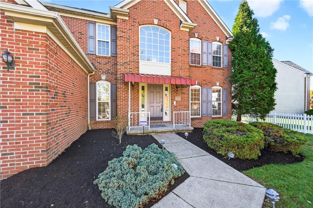 809 Wible Run Road Pittsburgh, PA 15209 - Photo 2 of 36 a view of a brick house with many windows plants and large tree