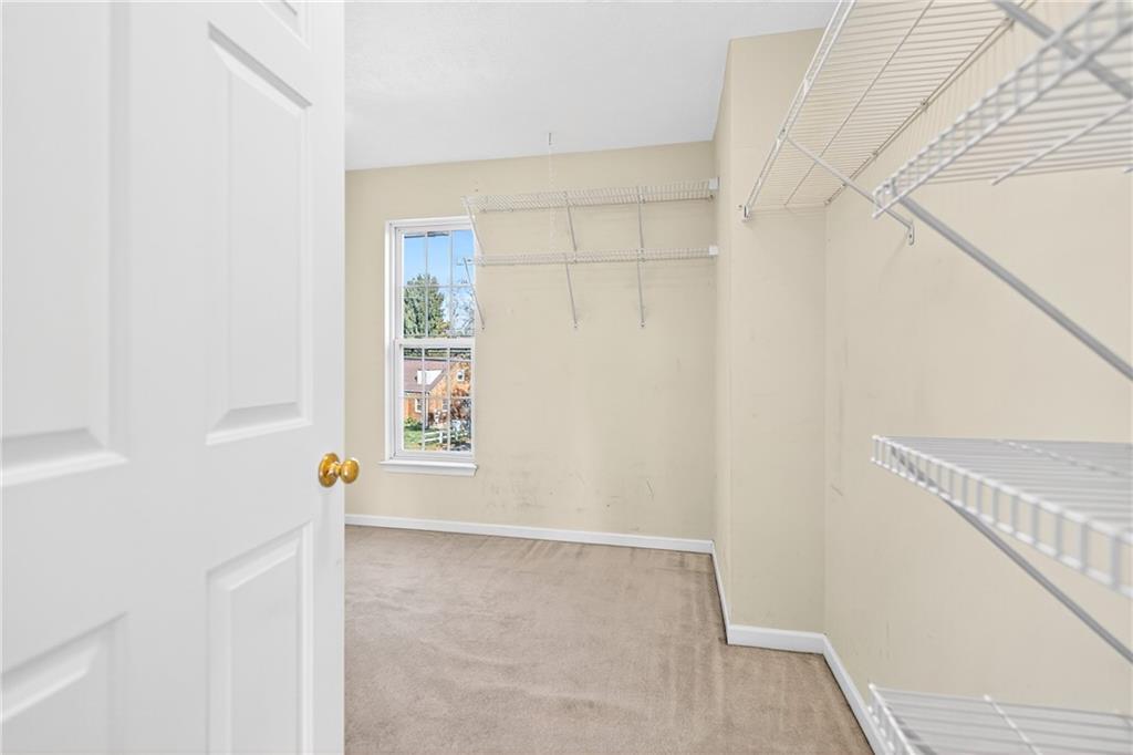 809 Wible Run Road Pittsburgh, PA 15209 - Photo 21 of 36 a view of an empty room with wooden floor and a window