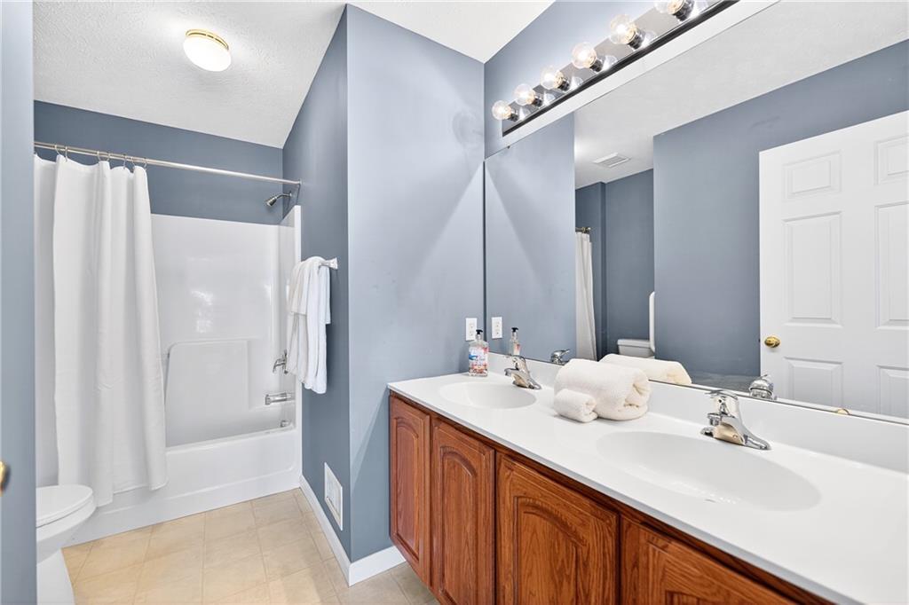 809 Wible Run Road Pittsburgh, PA 15209 - Photo 26 of 36 a bathroom with double vanity sinks and a mirror