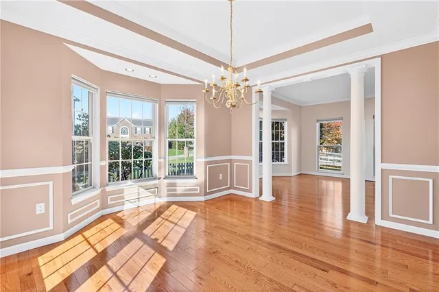a view of an entryway with wooden floor and door