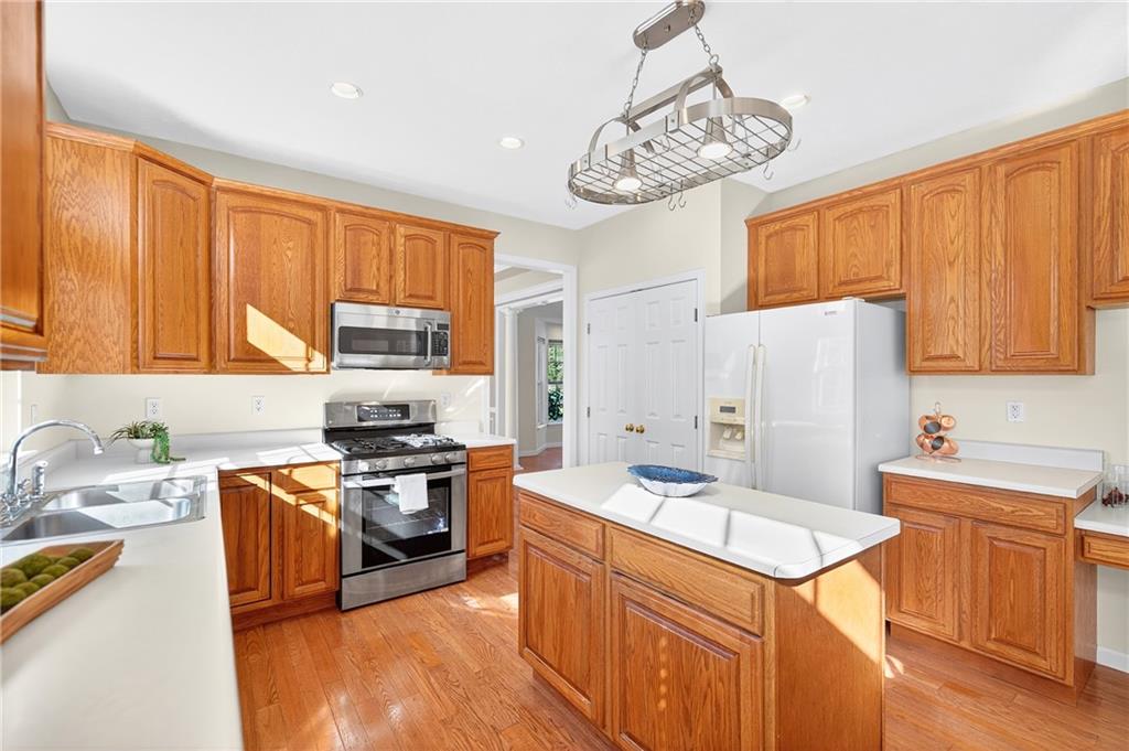 809 Wible Run Road Pittsburgh, PA 15209 - Photo 9 of 36 a kitchen with stainless steel appliances granite countertop a sink stove and refrigerator
