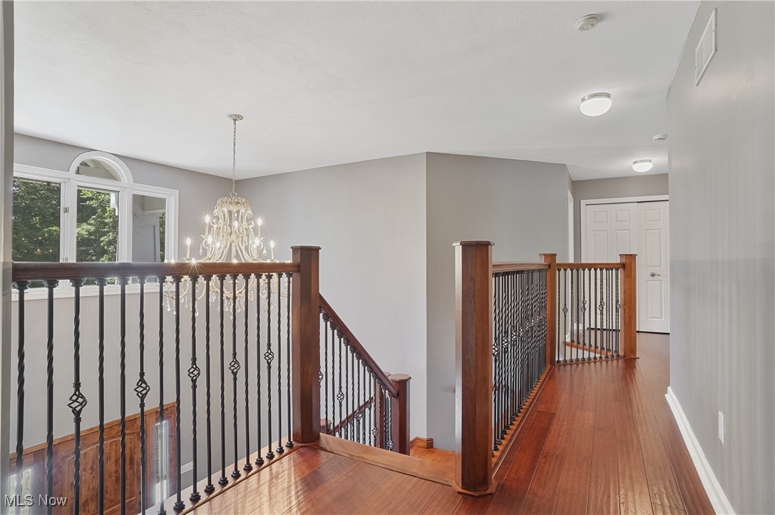 1453 Prospect Road Hudson, OH 44236 - Photo 21 of 50 Corridor featuring an upstairs landing, hardwood / wood-style flooring, and a chandelier
