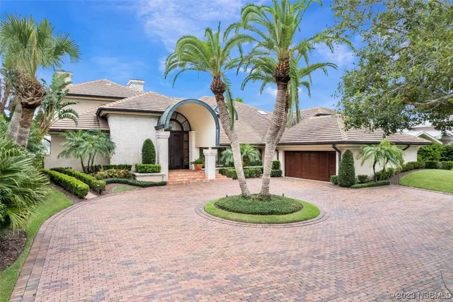 a front view of a house with a garden and plants