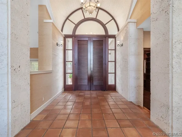 a view of a hallway with wooden floor and a living room